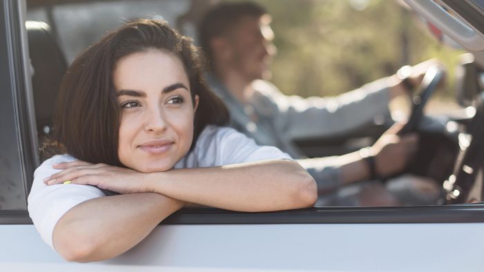 medium shot couple traveling by car