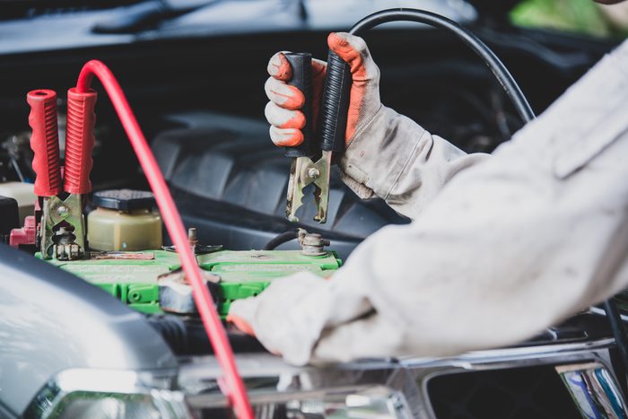 car repairman wearing white uniform standing holding wrench that is essential tool mechanic