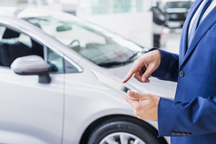 car salesman with tablet
