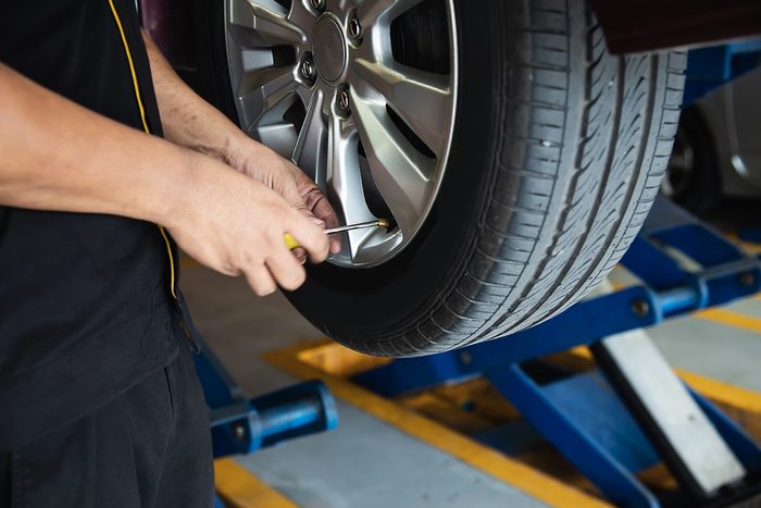 technician is inflate car tire car maintenance service transportation safety 1