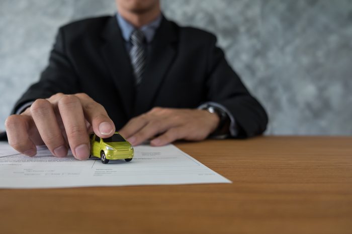 transportation ownership concept customer salesman with car key 2