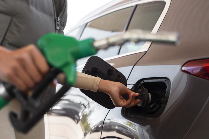 view woman with car gas station
