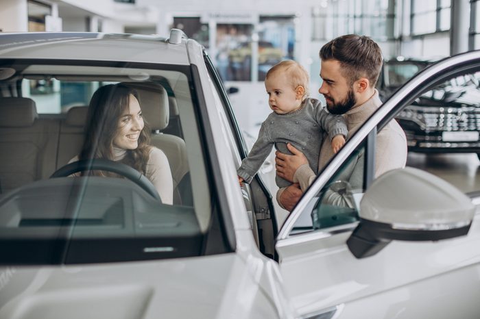 young family with baby girl choosing car 1